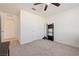 Bright bedroom with ceiling fan, closet, and neutral carpeting at 3981 E Teller Dr, Pahrump, NV 89061