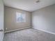 This is a simple bedroom with gray carpet, walls, and white trim with a double hung window at 414 Maritocca Ave, North Las Vegas, NV 89031