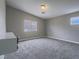 This is a simple bedroom with gray carpet, walls, and white trim with a double hung window and light at 414 Maritocca Ave, North Las Vegas, NV 89031