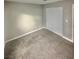 Neutral bedroom featuring gray walls, carpet, baseboards and a closet with white doors at 414 Maritocca Ave, North Las Vegas, NV 89031