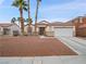 Charming single-story home features desert landscaping, a two-car garage, and a classic, neutral-toned stucco exterior at 414 Maritocca Ave, North Las Vegas, NV 89031