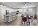 Eat-in kitchen with island, stainless steel appliances, and red barstools at 414 Maritocca Ave, North Las Vegas, NV 89031