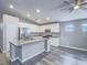 Open kitchen with a center island, stainless appliances and a gray backsplash at 414 Maritocca Ave, North Las Vegas, NV 89031