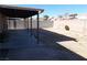 Large backyard with covered patio, block wall, and mature plants at 4522 Checker Way, North Las Vegas, NV 89031