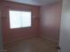 Charming bedroom with pink walls and wood-look flooring at 4522 Checker Way, North Las Vegas, NV 89031