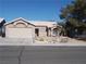 Single-story house with a two-car garage and desert landscaping at 4522 Checker Way, North Las Vegas, NV 89031