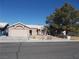 Single-story house with a two-car garage and landscaped yard at 4522 Checker Way, North Las Vegas, NV 89031