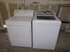 White washer and dryer in a laundry room at 4522 Checker Way, North Las Vegas, NV 89031