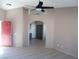 Living room with high ceilings, ceiling fan, and red front door at 4522 Checker Way, North Las Vegas, NV 89031