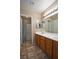 Double sink bathroom with wood cabinets and shower/tub combo at 5066 El Castano Ave, Las Vegas, NV 89108