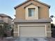 Two-story house with beige exterior, attached garage, and landscaping at 5066 El Castano Ave, Las Vegas, NV 89108