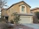 Two-story house with attached garage, landscaping, and a circular window at 5066 El Castano Ave, Las Vegas, NV 89108