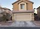 Tan two-story house with attached garage and small front yard at 5066 El Castano Ave, Las Vegas, NV 89108