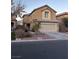 Two-story house with beige exterior, attached garage, and landscaping at 5066 El Castano Ave, Las Vegas, NV 89108