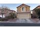 Two-story house with beige exterior, attached garage, and landscaping at 5066 El Castano Ave, Las Vegas, NV 89108