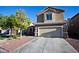 Two story house with attached garage and landscaping at 5066 El Castano Ave, Las Vegas, NV 89108