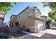 Two-story house with attached garage and desert landscaping at 5066 El Castano Ave, Las Vegas, NV 89108