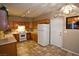 Kitchen with wood cabinets, white appliances, and tile floor at 5066 El Castano Ave, Las Vegas, NV 89108