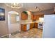 Kitchen with wood cabinets, tile floor, and white appliances at 5066 El Castano Ave, Las Vegas, NV 89108