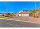 Two-story house with a tile roof, two-car garage, and landscaped yard at 5112 Palm View Dr, Las Vegas, NV 89130