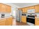 Kitchen with stainless steel appliances and wood cabinets at 5112 Palm View Dr, Las Vegas, NV 89130