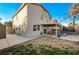 Spacious backyard featuring a covered patio, trampoline, and mature landscaping at 6104 Talbot Springs Ct, North Las Vegas, NV 89081