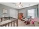 Bright Bedroom featuring a crib, rocker, and plenty of storage at 6104 Talbot Springs Ct, North Las Vegas, NV 89081