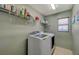 Laundry room with washer, dryer, and overhead shelving at 6104 Talbot Springs Ct, North Las Vegas, NV 89081