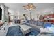 Open-concept living room with a large sectional sofa and views into the dining area and kitchen at 6104 Talbot Springs Ct, North Las Vegas, NV 89081