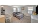 Bright loft with grey sectional sofa and cat tree at 6104 Talbot Springs Ct, North Las Vegas, NV 89081