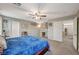 Main bedroom with king bed, ceiling fan, and adjacent bathroom at 6104 Talbot Springs Ct, North Las Vegas, NV 89081