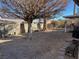 Landscaped backyard with gravel, mature tree, and patio at 6256 Hill Haven Ave, Las Vegas, NV 89130