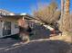 Landscaped backyard with mature trees and a covered patio at 6256 Hill Haven Ave, Las Vegas, NV 89130