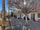 Spacious backyard with covered patio, mature trees, and a large grassy area at 6256 Hill Haven Ave, Las Vegas, NV 89130