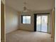 Bright bedroom featuring carpet, ceiling fan, and sliding glass door at 6256 Hill Haven Ave, Las Vegas, NV 89130