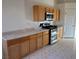 Efficient kitchen with wood cabinets and stainless steel appliances at 6256 Hill Haven Ave, Las Vegas, NV 89130