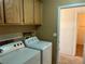 Laundry room with washer, dryer, and ample cabinet storage at 6256 Hill Haven Ave, Las Vegas, NV 89130