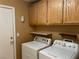 Laundry room with washer, dryer, cabinets, and access to another room at 6256 Hill Haven Ave, Las Vegas, NV 89130