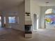 Spacious living room with a fireplace and views into the kitchen at 6256 Hill Haven Ave, Las Vegas, NV 89130