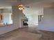 Open living room with a fireplace and access to kitchen and backyard at 6256 Hill Haven Ave, Las Vegas, NV 89130