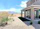 Landscaped backyard with covered patio and mountain views at 630 Moonbeam Way, Mesquite, NV 89027