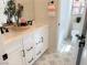 Double vanity bathroom with white cabinets, quartz countertops, and patterned floor tile at 630 Moonbeam Way, Mesquite, NV 89027