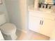 Stylish powder room with white cabinets, quartz countertop, and patterned tile floor at 630 Moonbeam Way, Mesquite, NV 89027