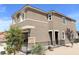 Two-story home with attached garage, modern design and desert landscaping at 630 Moonbeam Way, Mesquite, NV 89027