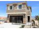 Two-story home with attached garage, desert landscaping, and mountain views at 630 Moonbeam Way, Mesquite, NV 89027