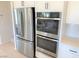 Stainless steel refrigerator and double oven add to this kitchen's appeal at 630 Moonbeam Way, Mesquite, NV 89027