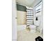 Bright bathroom with a shower and tub combo, white tile, neutral walls, and window at 6449 Stone Dry Ave # 101, Henderson, NV 89011