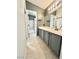 Bathroom featuring a large vanity with gray cabinets, tile flooring, and a view into the shower at 6449 Stone Dry Ave # 101, Henderson, NV 89011