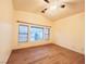 Bedroom featuring vaulted ceiling, wood floors, a ceiling fan, and a large window with blinds at 6449 Stone Dry Ave # 101, Henderson, NV 89011