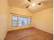 Bright bedroom featuring light hardwood flooring, large window, and ceiling fan at 6449 Stone Dry Ave # 101, Henderson, NV 89011